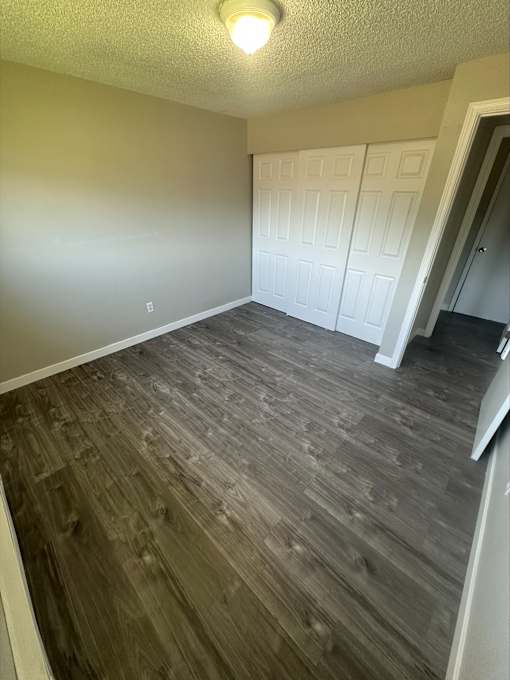 A room with wood flooring and white walls.