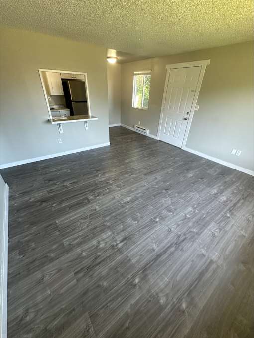 A room with a grey floor and a white door.
