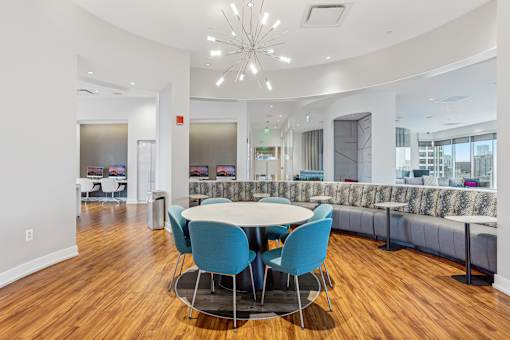 A conference room with a round table and blue chairs.