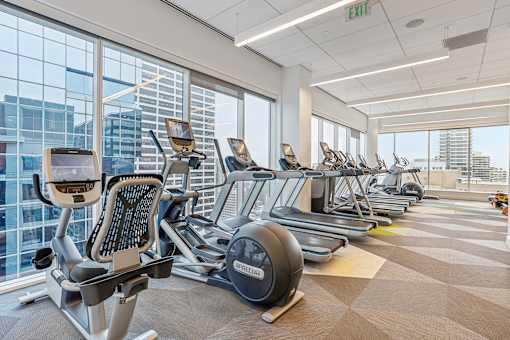 A gym with treadmills, exercise bikes, and elliptical machines.