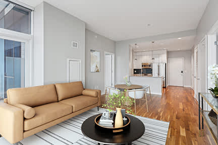 A living room with a tan couch and a coffee table.