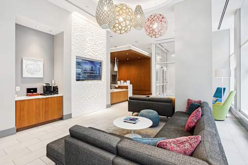 A modern living room with a grey sofa and a coffee table.