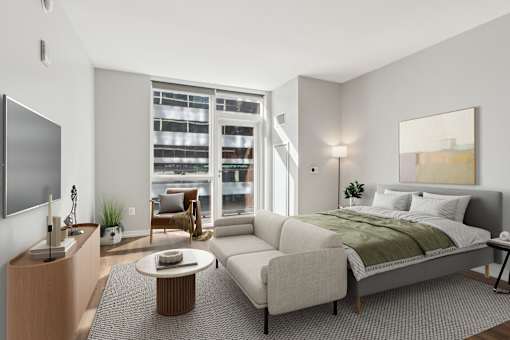 A modern bedroom with a large bed, a television, and a view of the city.