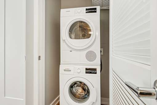 A white washing machine and dryer in a small laundry room.