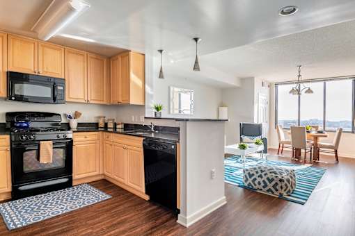 A kitchen with wooden cabinets and black appliances.