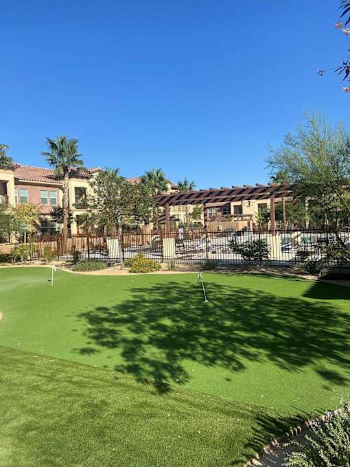 A green lawn in front of a building.at The Villas 55+ II Hesperia, California  
