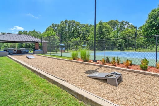 a tennis court with a ping pong table and a pavilion in the background at The Madison of Tyler Apartment Homes, Tyler, 75703