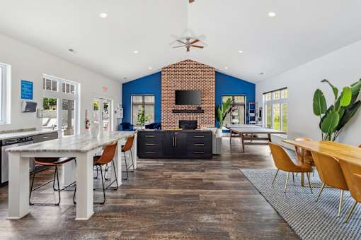 A modern open plan living and dining area with a brick fireplace. at Highland Village, Ross Township, Pittsburgh, PA 15229