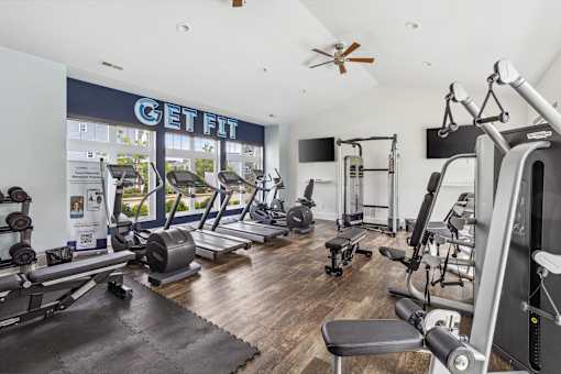A gym with a variety of equipment including treadmills, weights, and exercise machines. at Highland Village, Ross Township, Pittsburgh, PA 15229