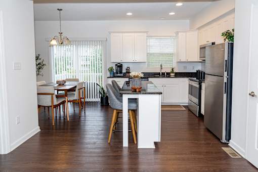 A kitchen with a dining table and chairs. at Highland Village, Ross Township, Pittsburgh, PA 15229