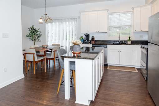 A kitchen with white cabinets and a black countertop. at Highland Village, Ross Township, Pittsburgh, PA 15229