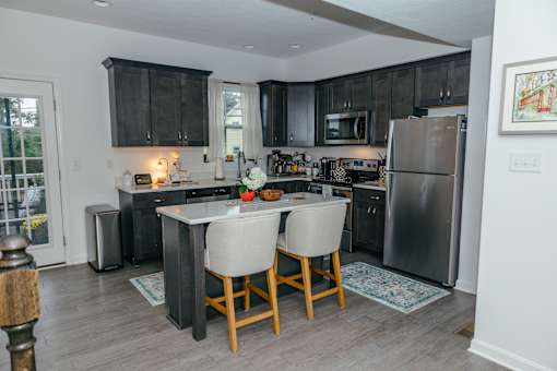 A kitchen with a table and chairs in the middle of it. at Highland Village, Ross Township, Pittsburgh, PA 15229