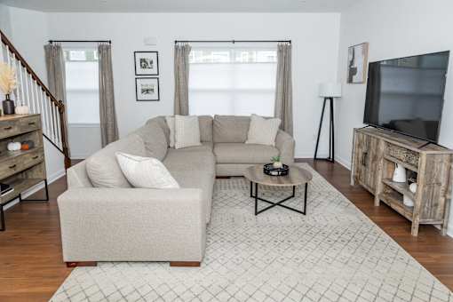 A living room with a couch, a coffee table, and a television. at Highland Village, Ross Township, Pittsburgh, PA 15229