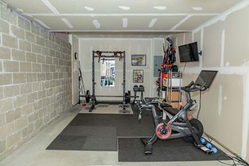 A room with a brick wall and a treadmill. at Highland Village, Ross Township, Pittsburgh, PA 15229