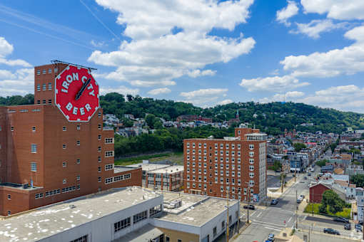 A view of a city with a large building that has a sign on it.at The Jones Tower at the Collective, Pittsburgh, PA 15203