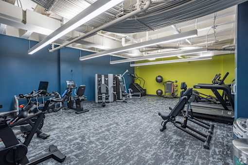 A gym with a variety of exercise equipment including treadmills, stationary bikes, and weight machines. at The Jones Tower at the Collective, Pittsburgh, PA 15203