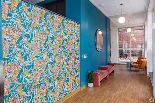 A room with a blue wall and a floral wallpaper.at The Jones Tower at the Collective, Pittsburgh, PA 15203