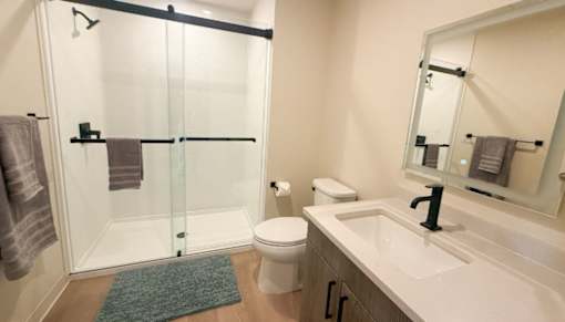A bathroom with a toilet, sink, and shower.at The Jones Tower at the Collective, Pittsburgh, PA 15203