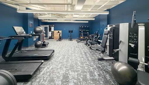 A spacious gym with treadmills, exercise machines, and weights.at The Jones Tower at the Collective, Pittsburgh, PA 15203