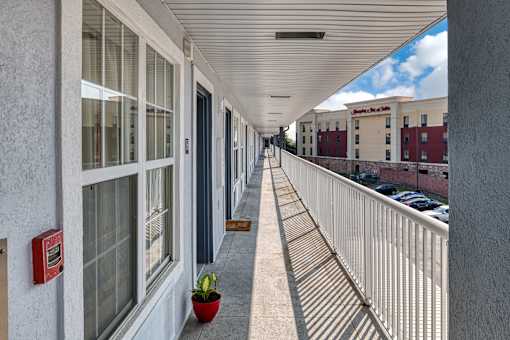 a balcony with a view of a parking lot