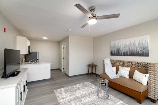 a living room with a couch and a ceiling fan