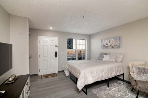 a bedroom with a bed and a tv