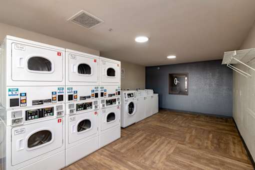 a laundry room with a bunch of washes and dryers