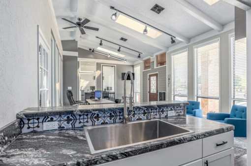 A modern kitchen with a large island and a sink.