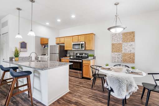 A modern kitchen with wooden cabinets and a white island.