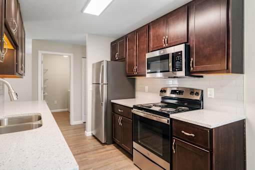A kitchen with brown cabinets and a white countertop.