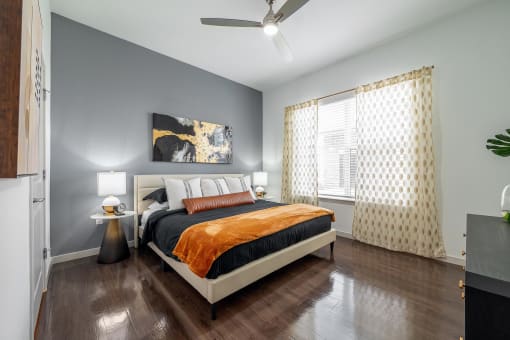 Bedroom with a Bed and a Ceiling Fan at AVILA Apartments, Oviedo, FL 32765
