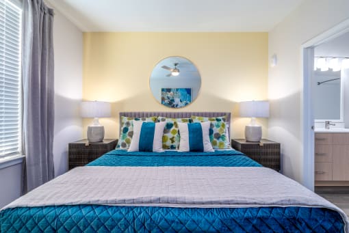 a bedroom with a large bed and two night stands with lamps at Alta at Horizon West, Winter Garden