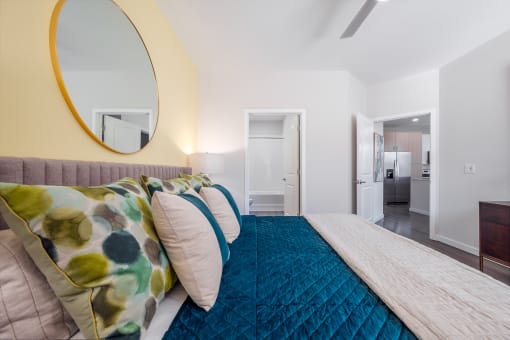 a bedroom with a large bed and a mirror on the wall at Alta at Horizon West, Winter Garden