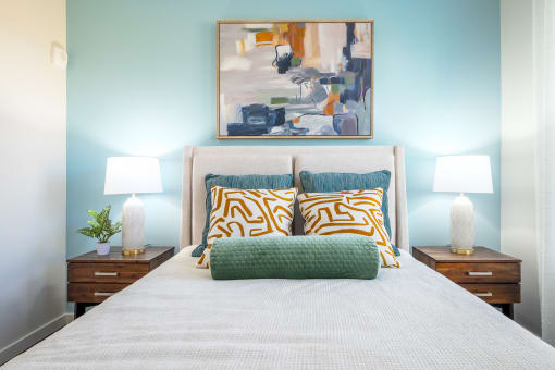 a bedroom with a bed and two night stands with lamps  at Alta at Horizon West, Winter Garden