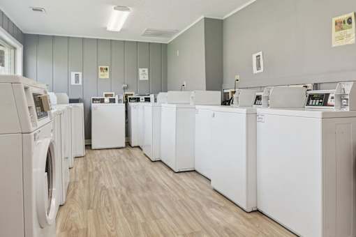 A laundromat with rows of washers and dryers.
