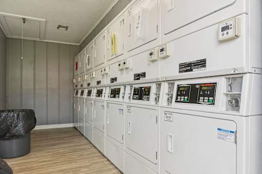 A control panel with many switches and gauges in a room.