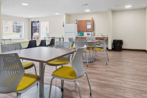 A conference room with a long table and chairs.