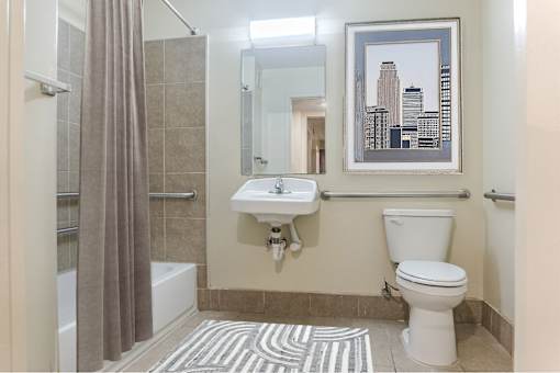 A bathroom with a toilet, sink, and shower.