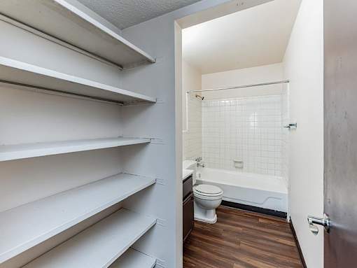 A white bathroom with a toilet and a walk in shower.