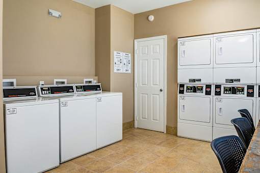 A laundry room with washers and dryers.