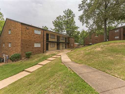 A brick building with a walkway in front.