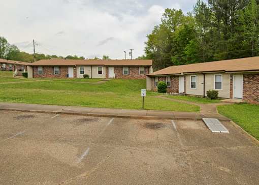 A parking lot in front of a row of houses.