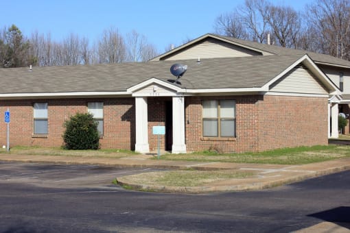 a brick house with a satellite dish on the roof