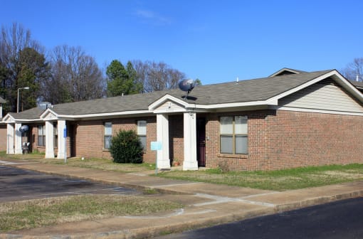 a brick building with a satellite dish on the roof