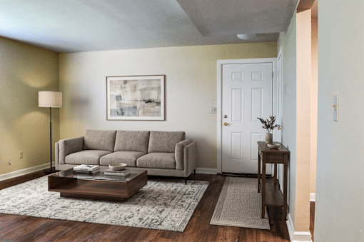 A living room with a grey couch and a coffee table.