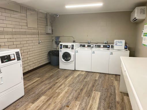 A row of washing machines in a laundromat.