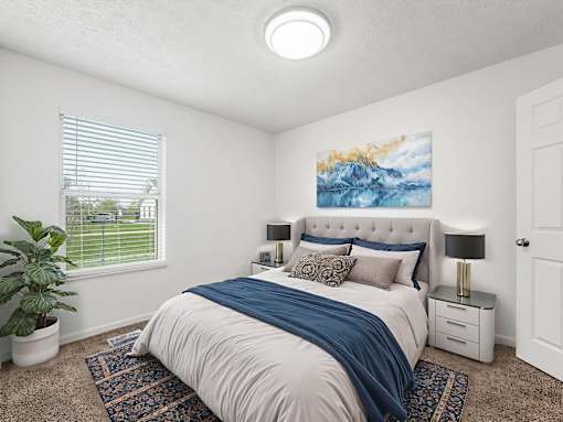 A bedroom with a large bed and a painting on the wall.