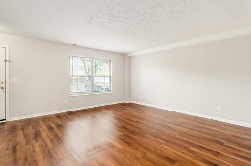 A room with wooden floors and a window.
