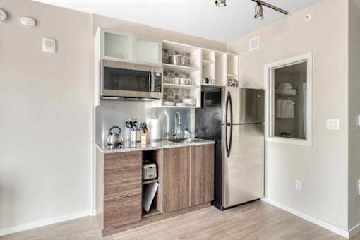 A kitchen with a refrigerator, microwave, and oven.at Sky Central, Cincinnati