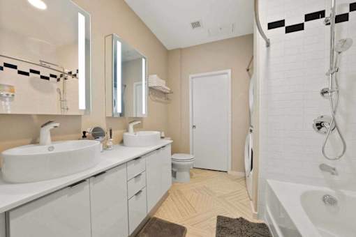 A bathroom with a white sink and a white bathtub.at Sky Central, Cincinnati Ohio